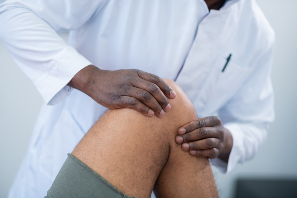 Doctor examining patient knee